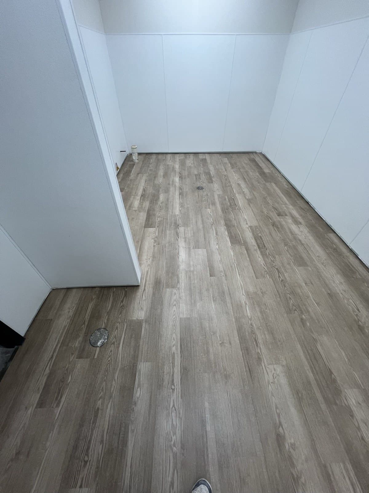 Wood-look LVP plank flooring in a freshly finished utility room